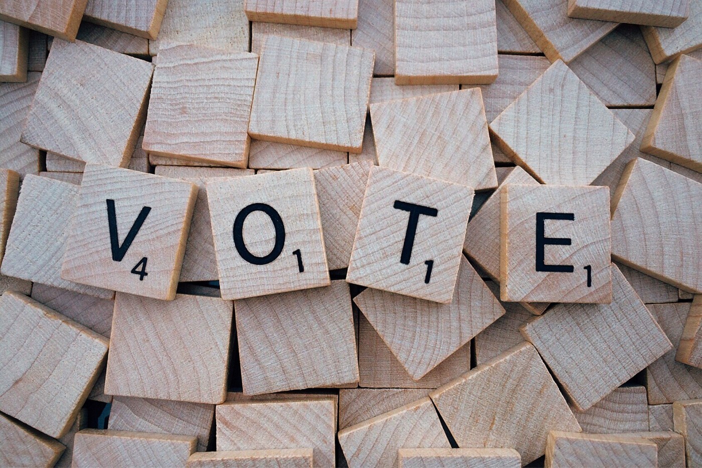 the word VOTE spelled with scrabble letter game tiles